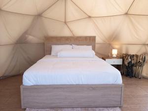 a bedroom with a bed in a tent at Hanara Private Glamping in Panjadakan
