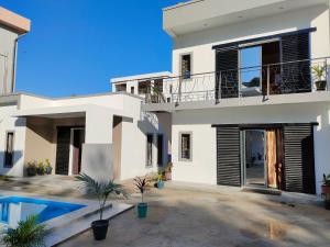 a house with a swimming pool in front of it at Residence Meva Soa Majunga in Amborovy