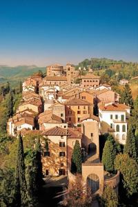 a village on top of a hill with buildings at Loft Elegante nel centro di Dozza, città d'Arte in Dozza
