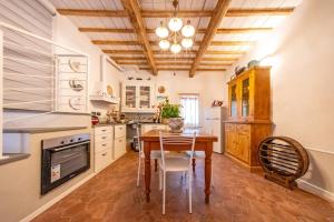 a kitchen with a wooden table and a wooden ceiling at Loft Elegante nel centro di Dozza, città d'Arte in Dozza +23 photos