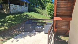 a porch of a house with a wooden fence at Vikendica Luka in Han Pijesak