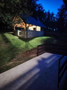 a path leading to a stone building with a fence at Vikendica Luka in Han Pijesak +30 photos