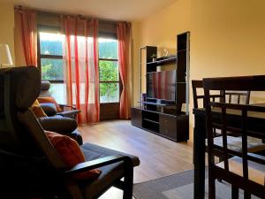 a living room with a flat screen tv and a couch at R2R - El Rincón de Luiña - 310A in Soto de Luiña