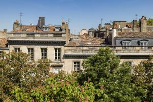 a group of buildings with trees in the foreground at Villas Foch Boutique Hotel & Spa Bordeaux in Bordeaux