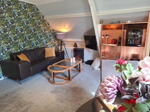 a living room with a couch and a table at Hof van Eden in Ophemert