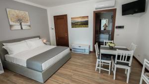 a bedroom with a bed and a table and a dining room at La Casatella Agriturismo in Alba +48 photos
