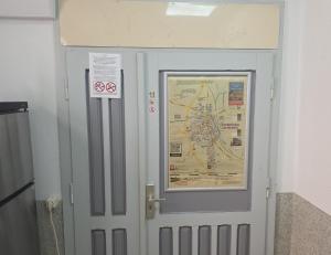 a door with a map and a sign on it at EG Ferien- und Monteurwohnung mit AC in Osterburg Siedlung