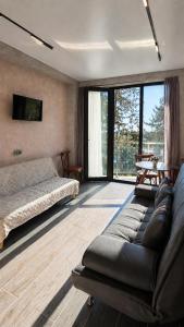 a living room with a couch and a bed at Kobuleti Lounge in Kobuleti