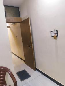 a room with a door and a chair and a table at SHRI VIJAYVEER PALACE in Ujjain