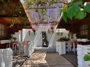 a patio with tables and chairs and potted plants at Camping Torremolinos in Torremolinos