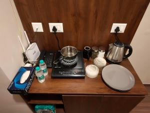 a table with a blender and other kitchen items on it at Sunlit Omaxe ITC, Greater Noida in Greater Noida +5 photos