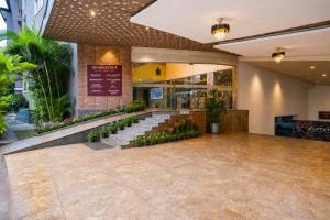 a restaurant with a row of stairs in a lobby at Summit Calangute Resort & Spa in Calangute