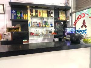 a bar in a restaurant with a counter with alcohol at Subhalaxmi Hotel and Lodge in Bahāsi