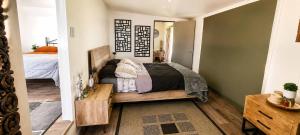 a bedroom with a bed in a room at Willow Cabin at The Reset Retreat in Charbon