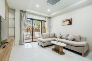 a living room with a couch and a table at Westkey Patong Hotel in Patong Beach