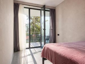 a bedroom with a bed and a sliding glass door at Kobuleti Lounge in Kobuleti