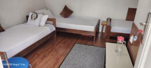 a small room with two beds and a table at Kosmaj - Sopot in Sopot +9 photos