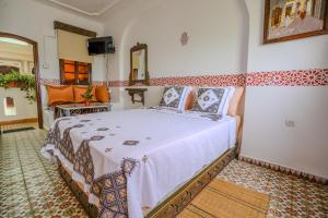 a bedroom with a large bed in a room at Riad Salt River in Martil +44 photos