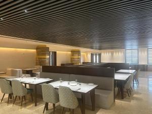a restaurant with tables and chairs in a room at Pride Resort Jodhpur in Banār