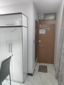 a room with a door and a chair next to a door at SHRI VIJAYVEER PALACE in Ujjain