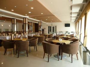 a dining room with tables and chairs in a restaurant at Hotel Auto Jas in Nitra