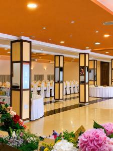 a banquet hall with white tables and white chairs at Hotel Auto Jas in Nitra
