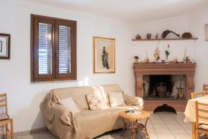a living room with a couch and a fireplace at Charming apartment in Nughedu Santa Vittoria - 90 m² with fireplace in Nughedu Santa Vittoria
