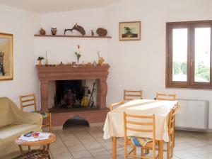 a living room with a table and a fireplace at Charming apartment in Nughedu Santa Vittoria - 90 m² with fireplace in Nughedu Santa Vittoria