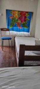 a room with two beds and a chair and a window at Kosmaj - Sopot in Sopot
