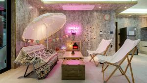 a room with chairs and a table and an umbrella at Chuncheon Poolhouse Epop in Chuncheon