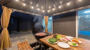 a room with a table with plates of food on it at Chuncheon Poolhouse Epop in Chuncheon