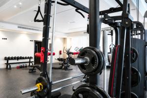 a gym with a lot of equipment and weights at Warwick Hotel Al Safa - Jeddah in Jeddah