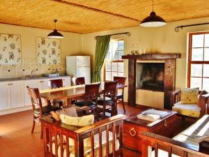 a kitchen and living room with a table and chairs at Rietfontein Guest Farm in Ladismith +46 photos