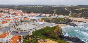 an aerial view of a town on the beach at Casa Saudade Beach House in Zambujeira do Mar