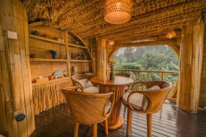 a room with a table and chairs on a balcony at Bamboo Villa with Amazing mount agung view in Selat