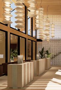 a lobby with large chandeliers in a building at Aura by Aubamar in Playa de Palma