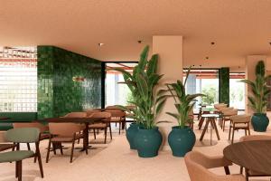 a restaurant with tables and chairs and potted plants at Aura by Aubamar in Playa de Palma