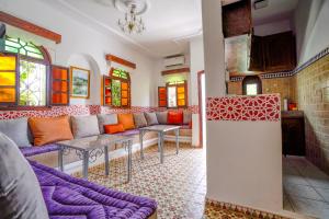 a living room with a couch and a table at Riad Salt River in Martil