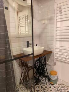 a bathroom with a sink and a mirror at Flóra Apartmanok in Kehidakustány +17 photos