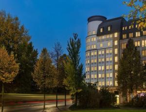 a tall building with a silo on the side of it at Sunday Hotel Leipzig in Leipzig