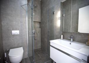 a bathroom with a shower and a toilet and a sink at Aqualina B3-2 by HolidayKeys in Kyrenia +16 photos