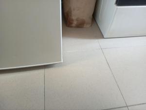 a white tiled floor in a kitchen with a refrigerator at Lieu inoubliable in Monte Carlo