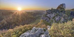 an image of the sun setting on a mountain at La Parenthèse d'Ouilly in Pont-d'Ouilly