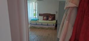 a bedroom with a bed with a window and a mirror at La Parenthèse d'Ouilly in Pont-d'Ouilly