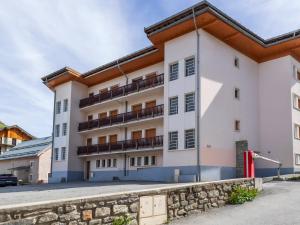 a large white building with a stone wall at Studio 2 pers. Sud avec balcon à Valloire - FR-1-263-53 in Valloire +7 photos