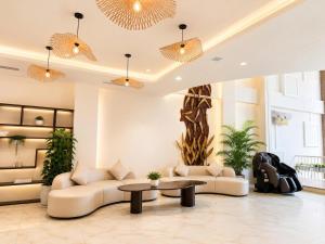a living room with couches and a table at LAVISH OCEAN INN Đà Nẵng in Danang
