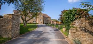 a road in front of a large brick house at The Lighthouse Bed & Breakfast in Frome