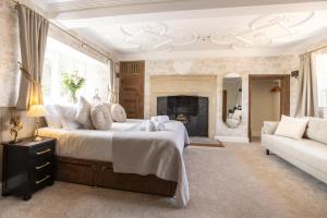 a bedroom with a large bed and a fireplace at The Lighthouse Bed & Breakfast in Frome