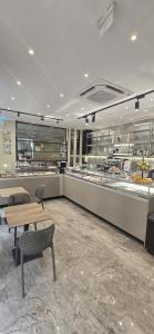a restaurant with a table and chairs and a counter at Hotel Elite Palermo Centro in Palermo