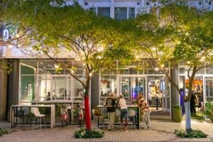 a group of people sitting at tables in front of a store at ONOMO Hotel Foreshore in Cape Town +47 photos